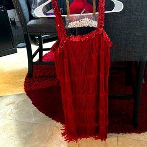 Red sequin and fringe flapper dress with rose hair, clip, and pearls accessories